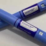 Close-up de uma caneta de aplicação do medicamento Mounjaro (tirzepatida) sobre uma superfície branca, simbolizando tratamento médico.