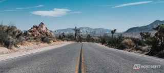 Vista de uma rodovia brasileira com foco em um smartphone no painel do carro exibindo mapa digital, simbolizando a melhoria da conexão de internet nas estradas.
