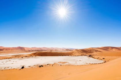 Termômetro digital marcando temperaturas extremas sob sol forte, ilustrando o aquecimento global e o recorde de calor previsto para 2027.